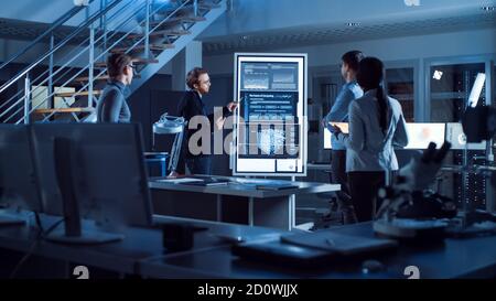Project Manager Does Motivational Presentation or Team of Electronics Development Engineers, he Uses Digital Whiteboard with Neural Network, AI and Stock Photo