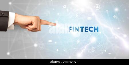 Hand pointing at FINTECH inscription, modern technology concept Stock Photo