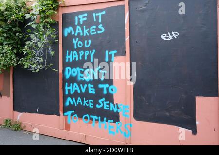 inspirational graffiti on a temporary building site hoarding Stock Photo