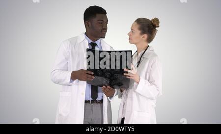 Serious nice woman doctor and afro american doctor study brain x Stock Photo