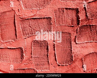 Trend photography on the theme of the color of the year 2019 - Living Coral. Real texture of plaster background with areas of rectangular depressions. Stock Photo
