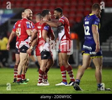 Salford Red Devils' Kallum Watkins (centre right) celebrates after the final whistle during the Coral Challenge Cup, Semi Final at The Totally Wicked Stadium, St Helens. Stock Photo