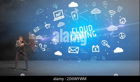 Businessman defending with umbrella from CLOUD GAMING inscription, modern technology concept Stock Photo