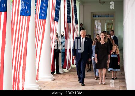President Donald J. Trump walks with Judge Amy Coney Barrett, his nominee for Associate Justice of the Supreme Court of the United States, along the West Wing Colonnade on Saturday, September 26, 2020, following announcement ceremonies in the Rose Garden. (USA) Stock Photo