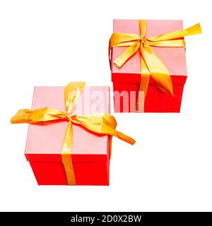 Two identical red gift boxes with gold ribbons on isolated background Stock Photo