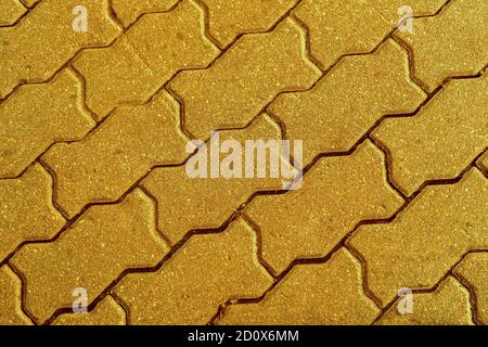 Geometric pattern made of square asphalt bricks in gold color Stock Photo