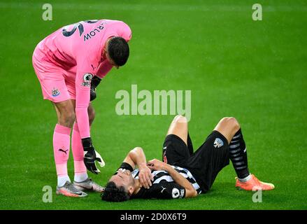 Newcastle United goalkeeper Karl Darlow helps up Newcastle United's Fabian Schar during the Premier League match at St James' Park, Newcastle. Stock Photo