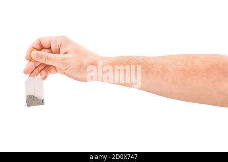 Male hand holding tea bag isolated on white background Stock Photo