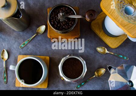 Coffee makers and beans, cup of coffee on the gray background Stock Photo