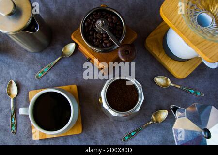 Coffee makers and beans, cup of coffee on the gray background Stock Photo
