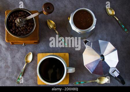 Coffee makers and beans, cup of coffee on the gray background Stock Photo