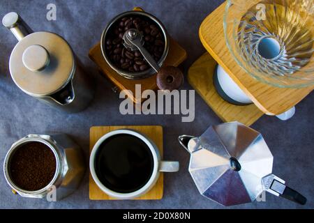 Coffee makers and beans, cup of coffee on the gray background Stock Photo