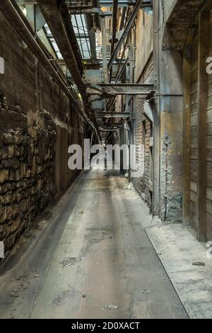 narrow aisle in a historic factory Stock Photo