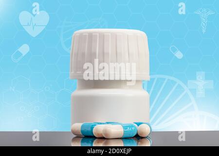 Antiviral drug in capsules with a white bottle on healthcare and science background. Medical innovation concept. Treatment of coronavirus symptoms Stock Photo