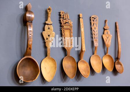 Different carved wooden spoons are seen arranged. Stock Photo