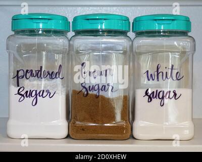 Labelled sugar storage cannisters on pantry shelf Stock Photo