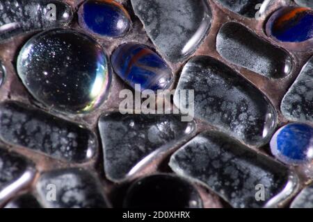 Details photo of different  glass stones bounded in iron Stock Photo