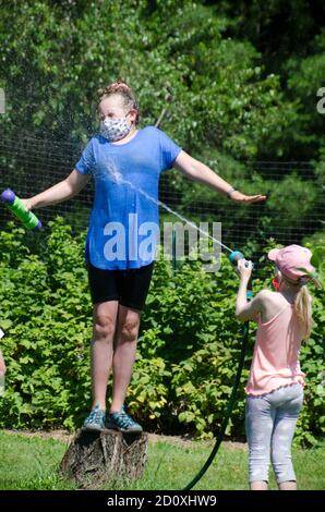 Campers at Garden camp, Yarmouth Community garden, playing with water, Yarmouth Maine, USA Stock Photo