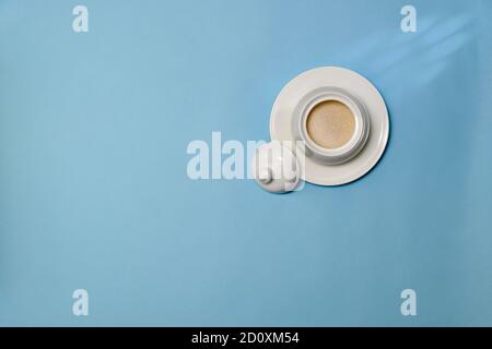 Sugar sand beetroot, cream-colored, in white ceramic sugar bowl, with open lid, on saucer.  Stock Photo