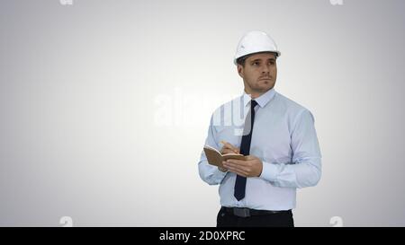 Man in helmet and formal clothes walking looking around and maki Stock Photo