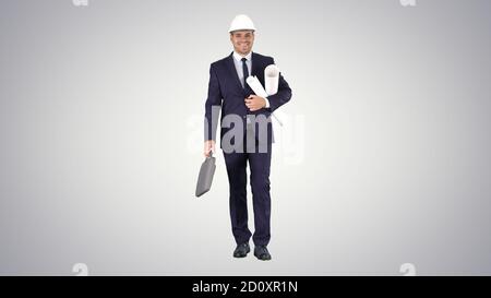 Smiling architect or engineer walking while keeping projects in Stock Photo