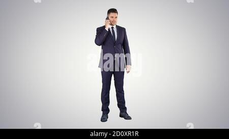 Thoughtful young businessman in suit and tie making several call Stock Photo