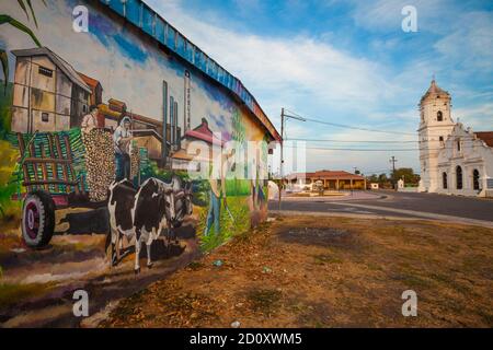 Wall painting and the church in the town Nata, Cocle province, Republic of Panama. Stock Photo