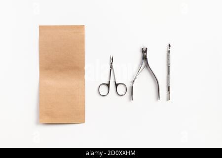 Tools for the manicure with paper bag on white table Stock Photo