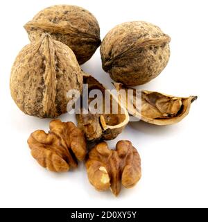 whole and peeled walnut kernels on a white background Stock Photo