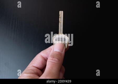 Key in hand on a black background Stock Photo