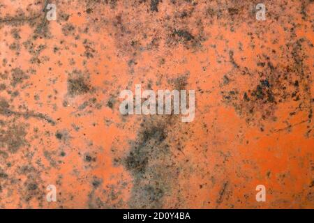old rusty iron sheet covered with faded red paint, background Stock Photo