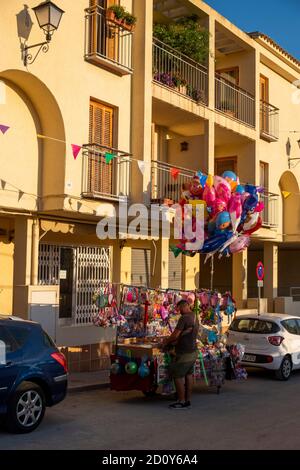 cheap plastic toys, American superheroes from the Marvel universe as plastic figures on a sales cart and helium filled balloons during summer Fiesta in the village of Altea La Vella, Spain on 27.72019 Stock Photo