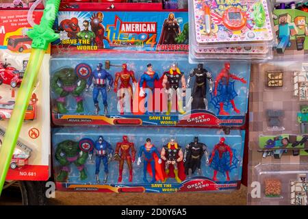 cheap plastic toys, American superheroes from the Marvel universe as plastic figures on a sales cart during summer Fiesta in the village of Altea La Vella, Spain Stock Photo