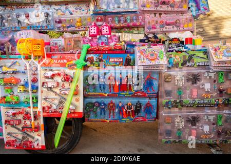 cheap plastic toys, American superheroes from the Marvel universe as plastic figures on a sales cart during summer Fiesta in the village of Altea La Vella, Spain Stock Photo