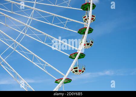 Detail of a coloful ferris wheel in front of a blue sky Stock Photo