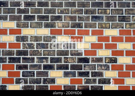 Background from a black, red and beige brick wall Stock Photo