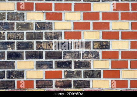 Background from a red, black and beige brick wall Stock Photo