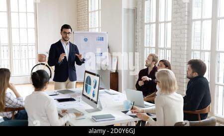 Confident male leader talk present project at meeting Stock Photo