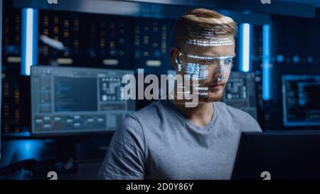 Young Software Programmer Working on Personal Computer in Digital Identity Cyber Security Data Center, Projected Program Coding Language Reflects His Stock Photo
