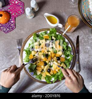 Woman eating tasty pumpkin salad top view Stock Photo