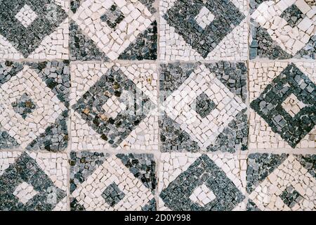 Close-up texture background mosaic in the form of squares with rhombuses in white and black. Stock Photo