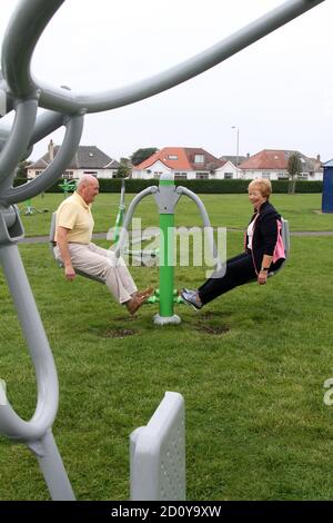 Ayr, Ayrshire, Scotland, 3 Sep 2014 : Retired elderly couple use the exercise equipment at Newton Park, Ayr Stock Photo