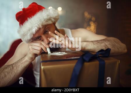 Bad Santa claus takes drugs, cocaine party, humor Stock Photo