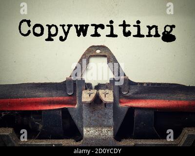 Closeup typed text copywriting written on sheet of paper in a mechanical typewriter Stock Photo