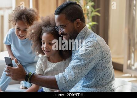 African ethnicity family recording dunny mobile video. Stock Photo