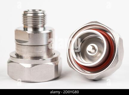 Microwave coaxial adapter 7 16 DIN Male To N Female connector. Concept of radio details. High frequency component with a metallic covering on white ba Stock Photo