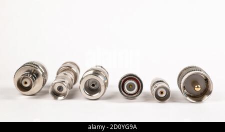 Microwave coaxial adapter UHF Male To N Female connector. Concept of radio details. High frequency component with a metallic covering on white backgro Stock Photo