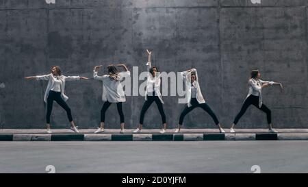 Premium Photo | The group of modern ballet dancers posing on gray  background.