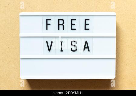 Lightbox with word free visa on wood background Stock Photo