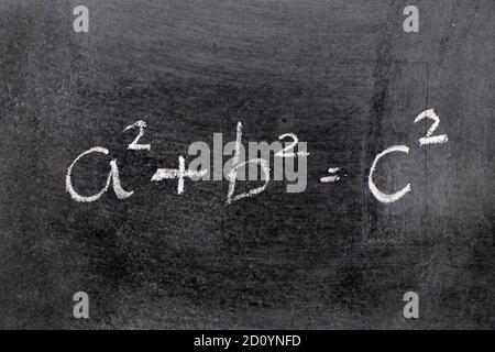 White color chalk hand writing in mathematics formula (Pythagorean theorem or Pythagoras's theorem) on blackboard background Stock Photo